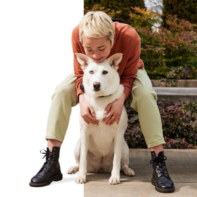 Woman hugging white dog