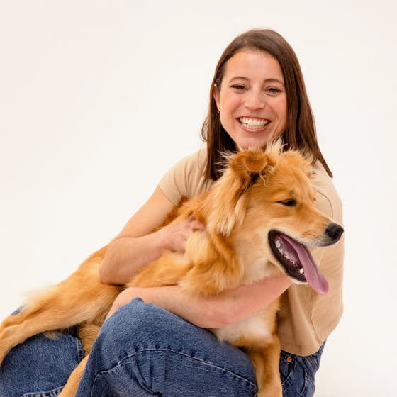 A lady holding a dog